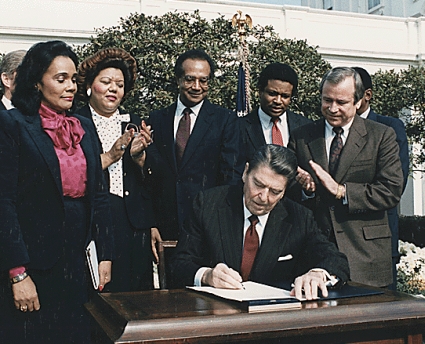 President Ronald Reagan signs Martin Luther King Holiday Bill.