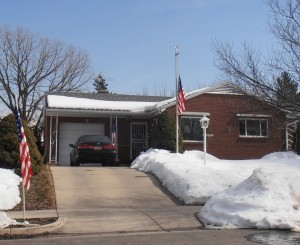 The home of Major General Sterling R. Ryser, with the flag displayed at half-staff